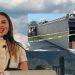 Mariana-rodriguez-y-muerte-en-metro-mundialista | La Silla Regia a Woman Speaks at a Podium Outdoors Against a Cloudy Sky, with an Inset Photo of a Construction Site Taped off with Caution Tape. | La Silla Regia