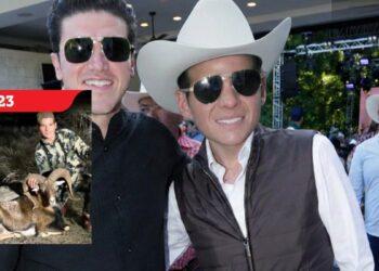 Two men in sunglasses at an outdoor event; one wears a white cowboy hat, with a 2023 hunting poster on the left.