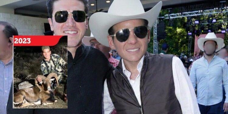 Two Men in Sunglasses at an Outdoor Event; One Wears a White Cowboy Hat, with a 2023 Hunting Poster on the Left. | La Silla Regia