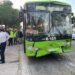 Front View of a Bright Green Bus with a Cracked Windshield and Dented Bumper After a Collision, with Emergency Responders and Bystanders on the Sidewalk | La Silla Regia